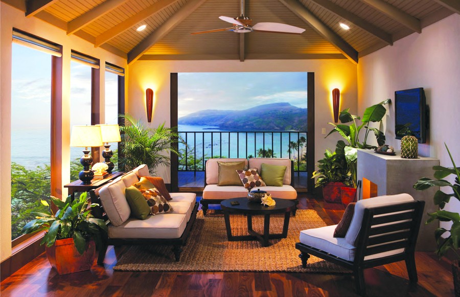 A living area with beautiful lighting and an ocean view. Lutron motorized shades are open.